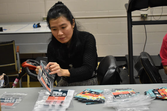 A Tamir day program participant preparing travel kits.