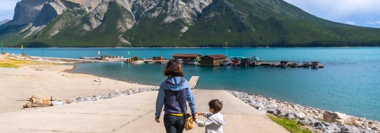Mère et fils marchant vers le lac Minnewanka dans le parc national de Banff