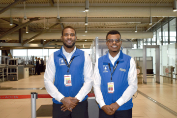 Two Facilitators standing in front of a CATSA Checkpoint