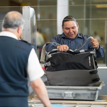 Passenger placing their carry-on in the bin