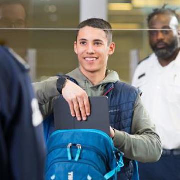 Passenger placing a laptop in a bin